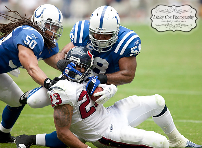 Houston Texans running back Arian Foster has his head twisted by linebackers Gary Brackett (58) and Phillip Wheeler (50) on a rush in the third quarter of a football game against the Indianapolis Colts on Sunday afternoon September 12, 2010 at Reliant Stadium in Houston. The Texans defeated the Colts 34-24 in the season opener.