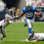 Indianapolis Colts running back Joseph Addai jumps past Houston Texans cornerback Glover Quin (29) and linebacker Zac Diles (54) safety Eugene Wilson on a rush in the second quarter of a football game against the Indianapolis Colts on Sunday afternoon September 12, 2010 at Reliant Stadium in Houston. The Texans defeated the Colts 34-24 in the season opener.