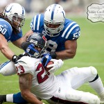 Houston Texans running back Arian Foster has his head twisted by linebackers Gary Brackett (58) and Phillip Wheeler (50) on a rush in the third quarter of a football game against the Indianapolis Colts on Sunday afternoon September 12, 2010 at Reliant Stadium in Houston. The Texans defeated the Colts 34-24 in the season opener.